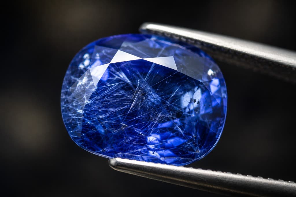 Illustrative macro view of needle-like inclusions inside a blue sapphire